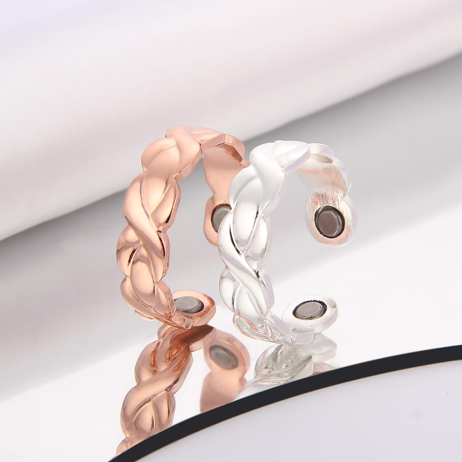bioMag copper ring magnets visible near fingertip with 3500 Gauss