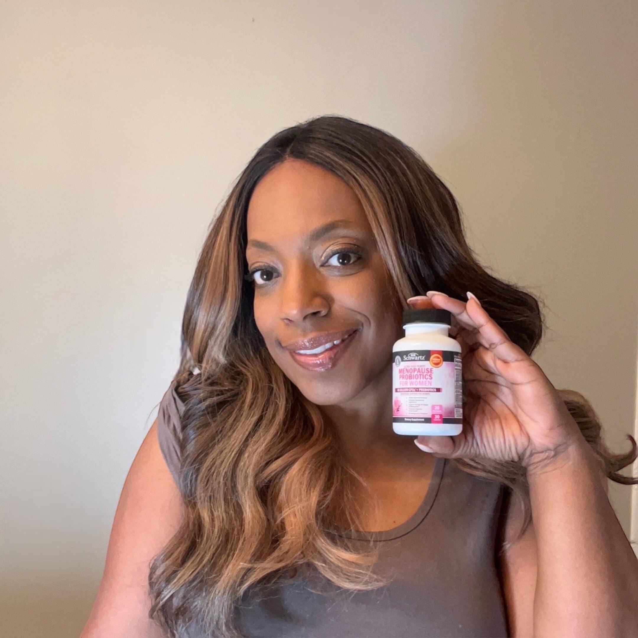 BioSchwartz menopause probiotics capsules in hand illustrate daily wellness routine.