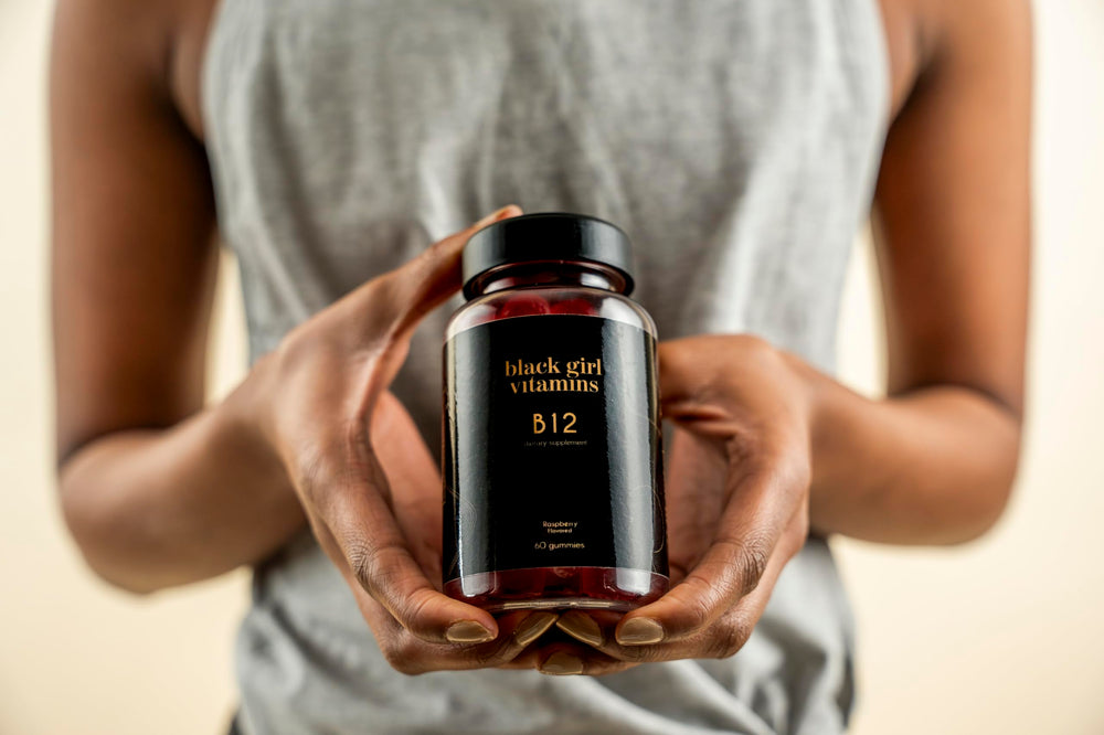 User taking a raspberry B12 gummy for daily energy with Black Girl Vitamins.
