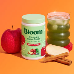 Bloom Nutrition greens powder with beet-root hue adding color and nutrients.