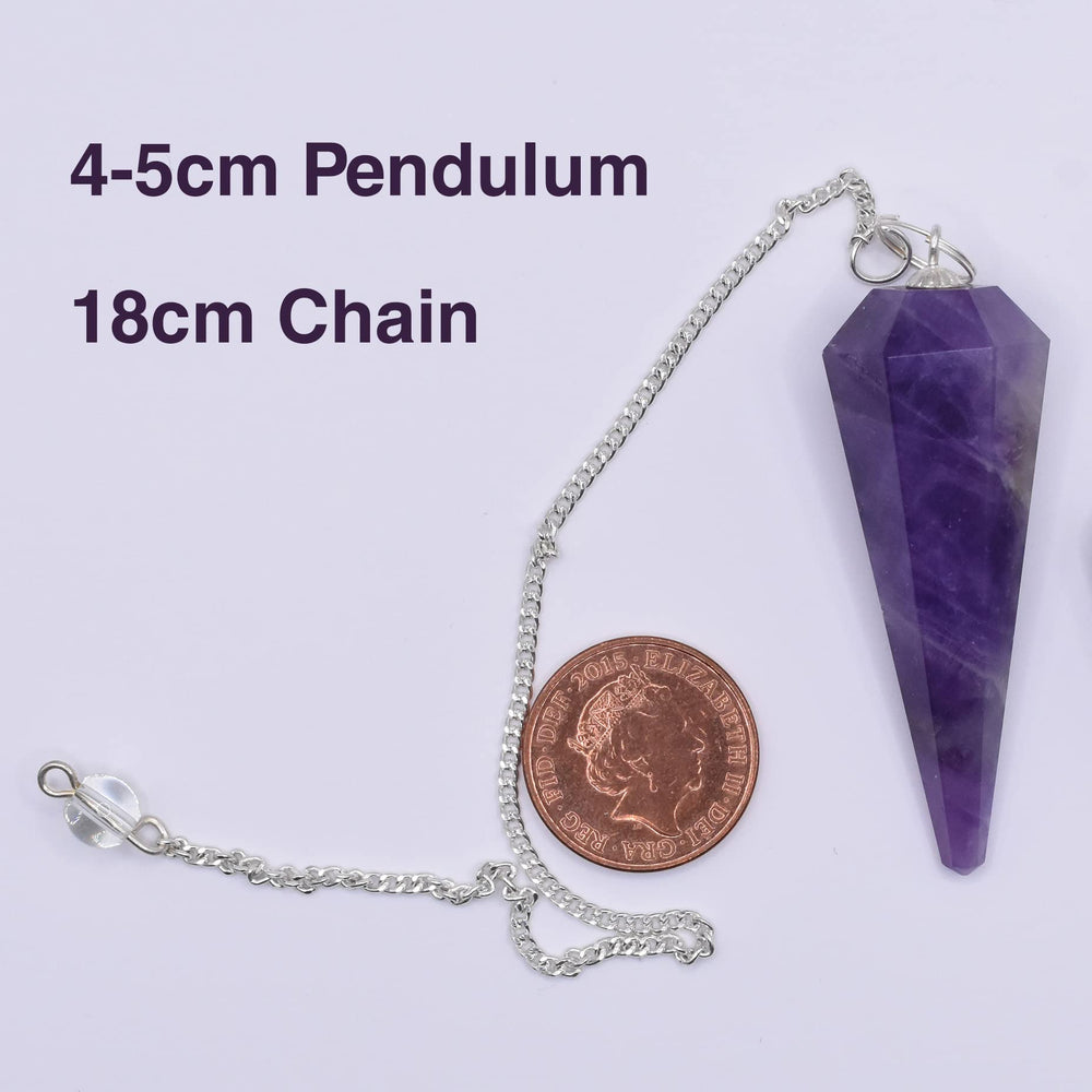 Blue Moon Pup amethyst pendulum on a calm surface evokes serene aesthetics for rituals.