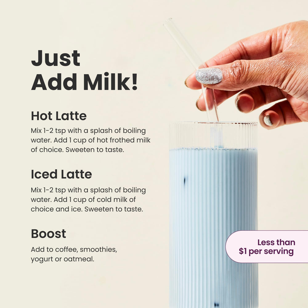 Blume Blue Lavender Powder spoon resting beside a glass of milky latte.