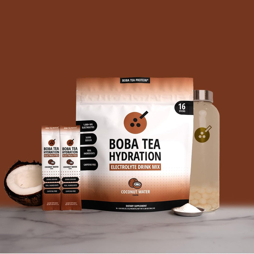 Boba Tea Hydration powder being stirred to dissolve with coconut water blend