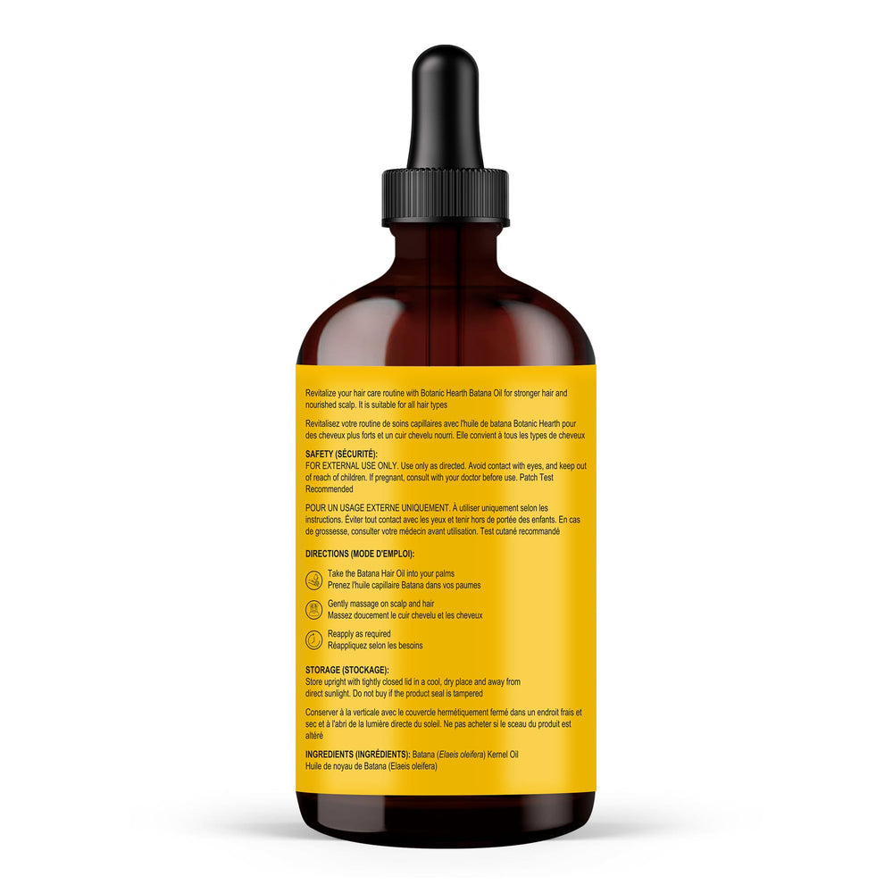Dropper pours Botanic Hearth Batana Oil for scalp nourishment.