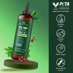 Botanic Hearth Tea Tree Hair Oil dropper delivering nourishment to hair.
