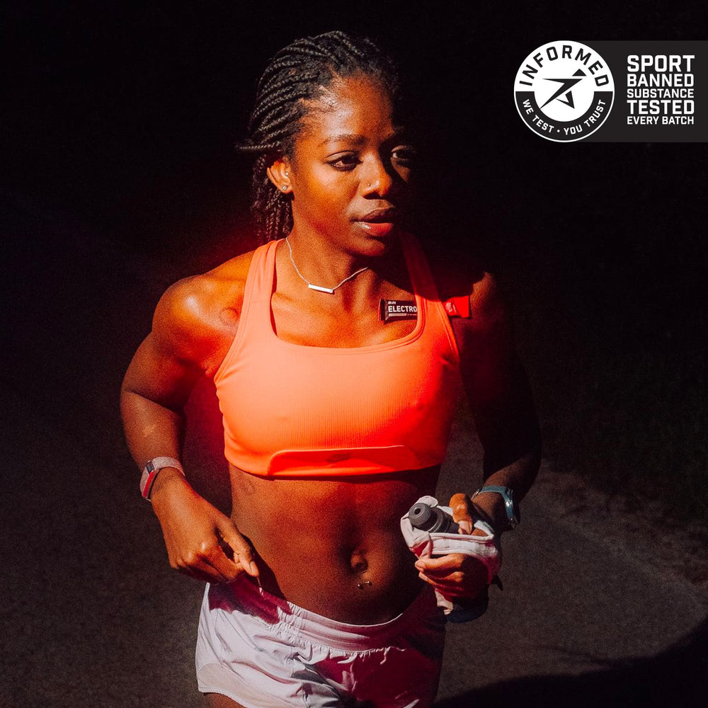 Bare Performance Nutrition electrolytes go packs mixed drink beside gym bottle for quick refreshment.