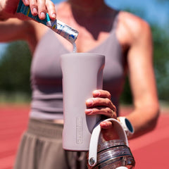BrüMate MultiShaker lid open in guava, showcasing easy spill-free pours.