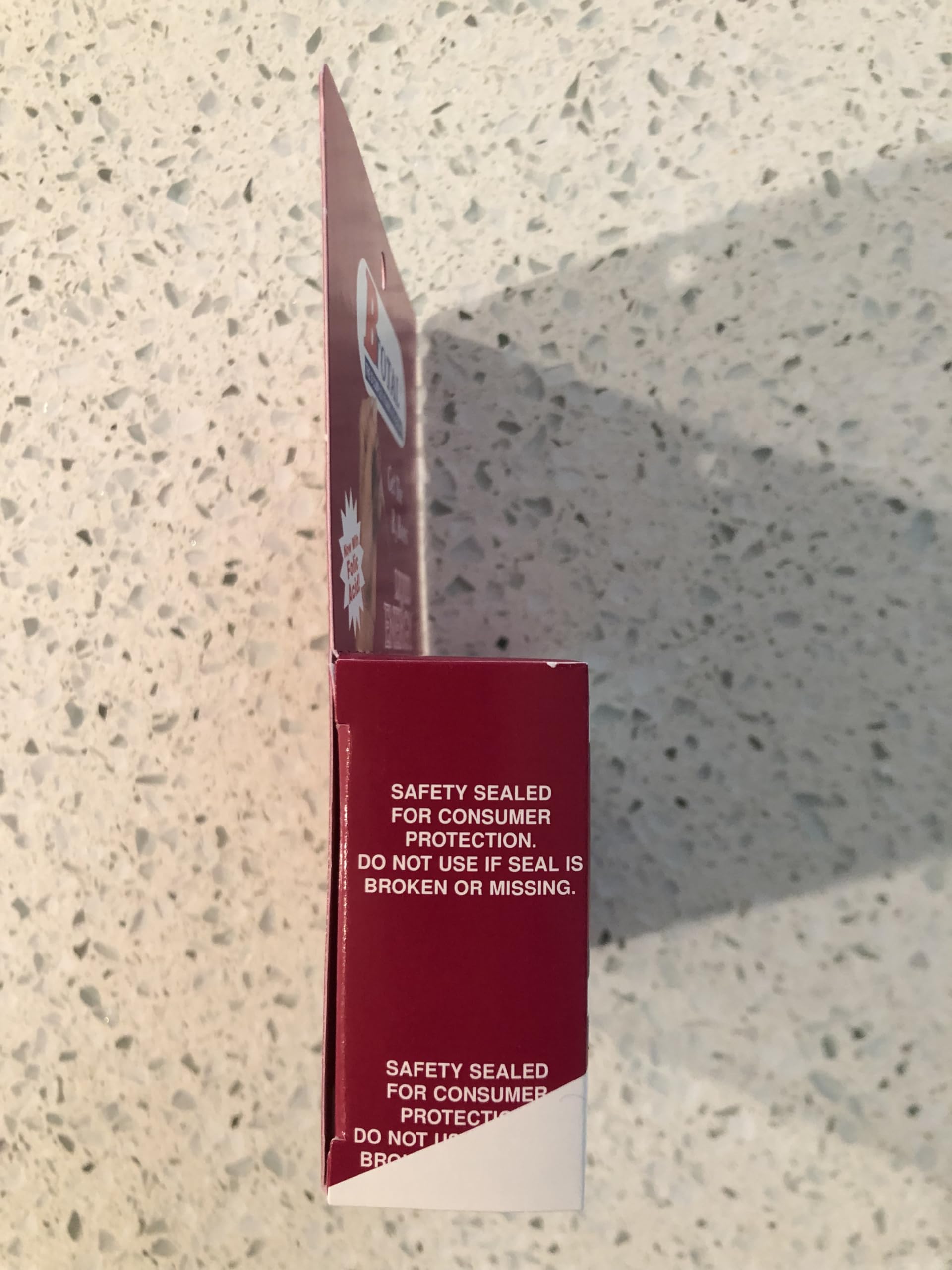 The B Total Solution on desk with glass suggests daily wellness routine.