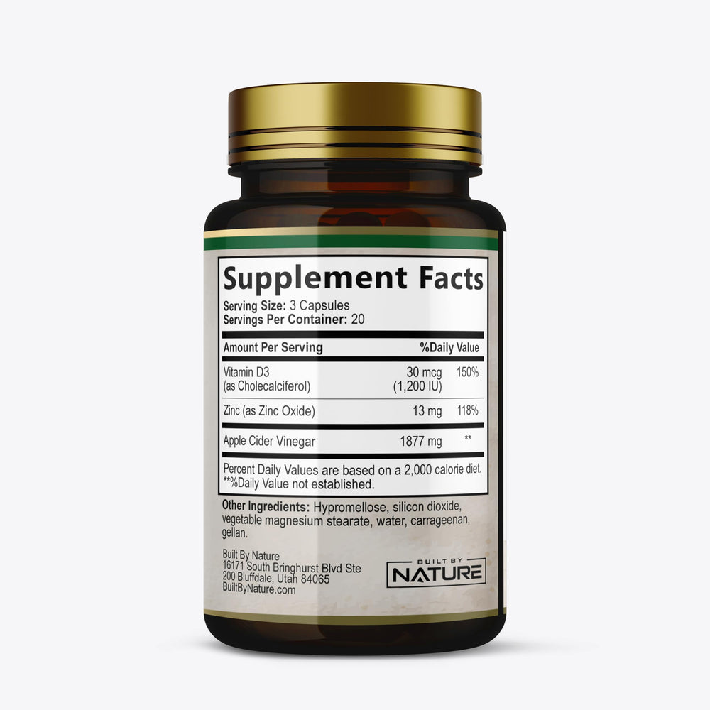 Built by Nature Apple Cider Vinegar capsules with a glass of water for easy daily intake.