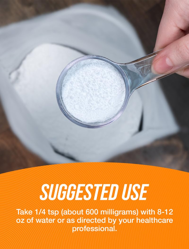 Pouring BulkSupplements NAC powder into a glass for a shake.