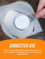 Pouring BulkSupplements NAC powder into a glass for a shake.
