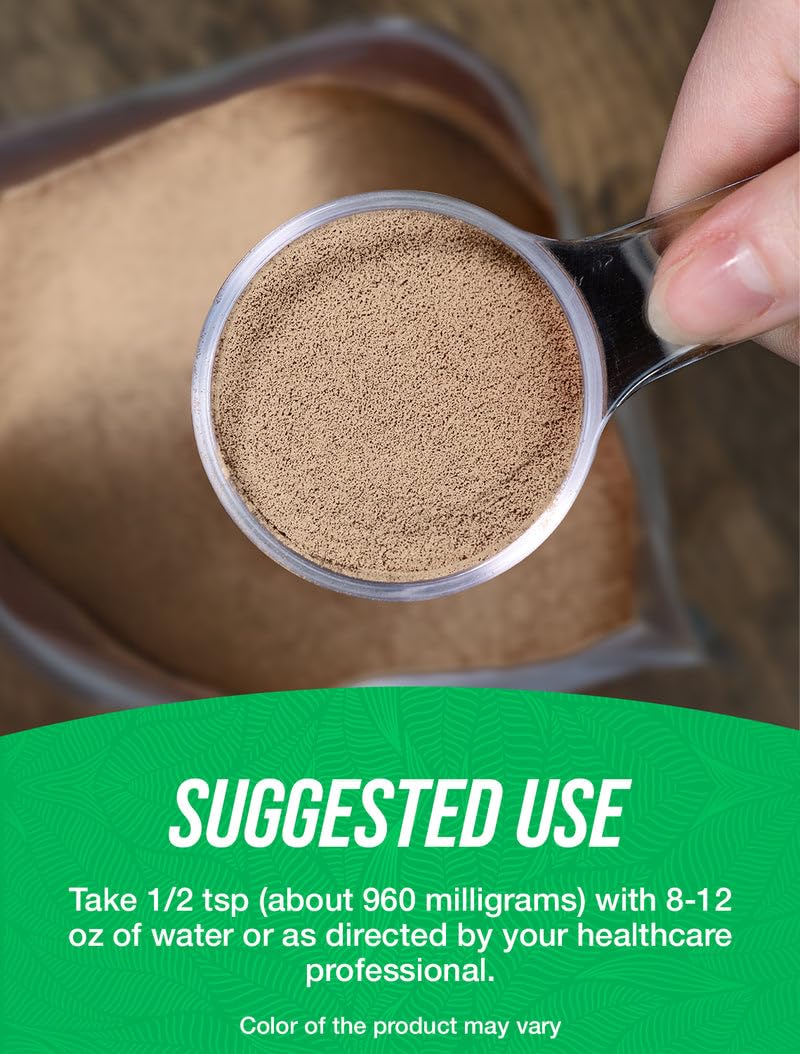 Glass of water with BulkSupplements Triphala powder prepared for daily use.