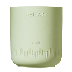 Caftari Elixir candle with bergamot, mandarin, and tea notes brightening a room