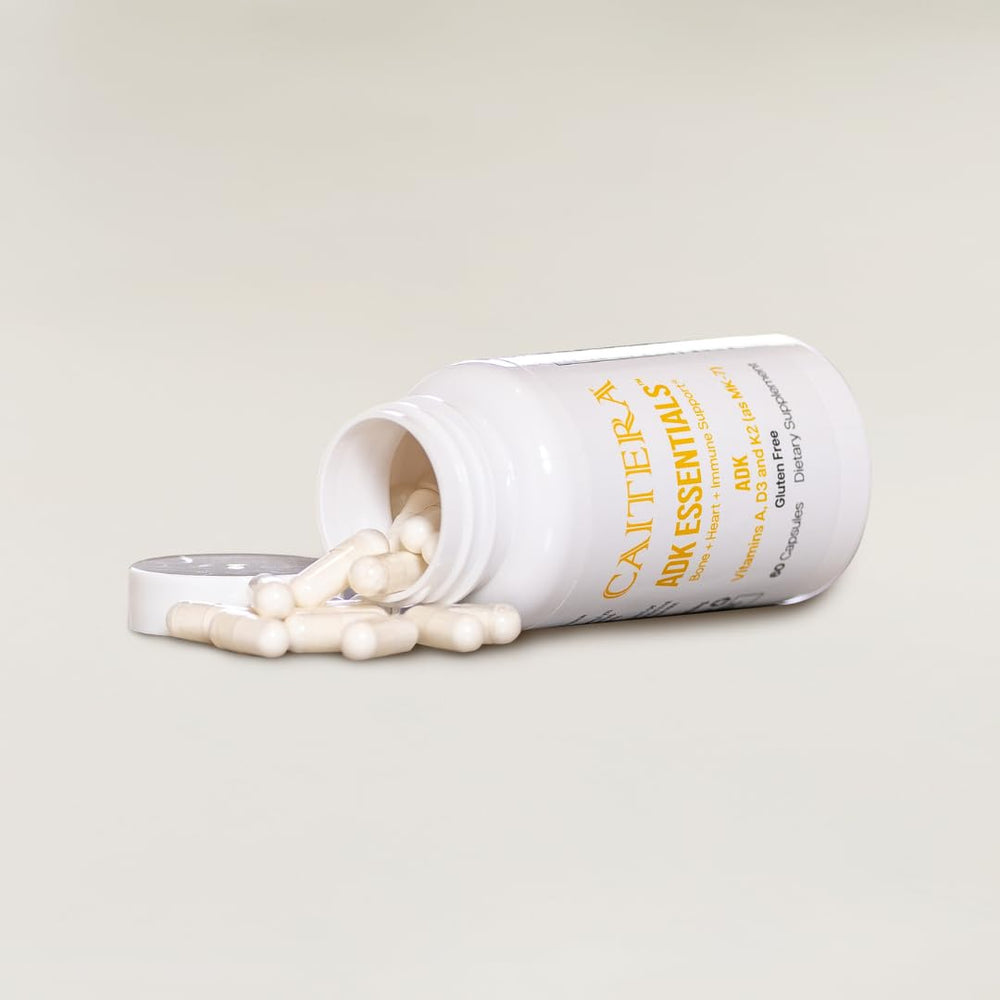 Caitera ADK Essentials bottle on neutral surface for daily vitamin routine and immune support.