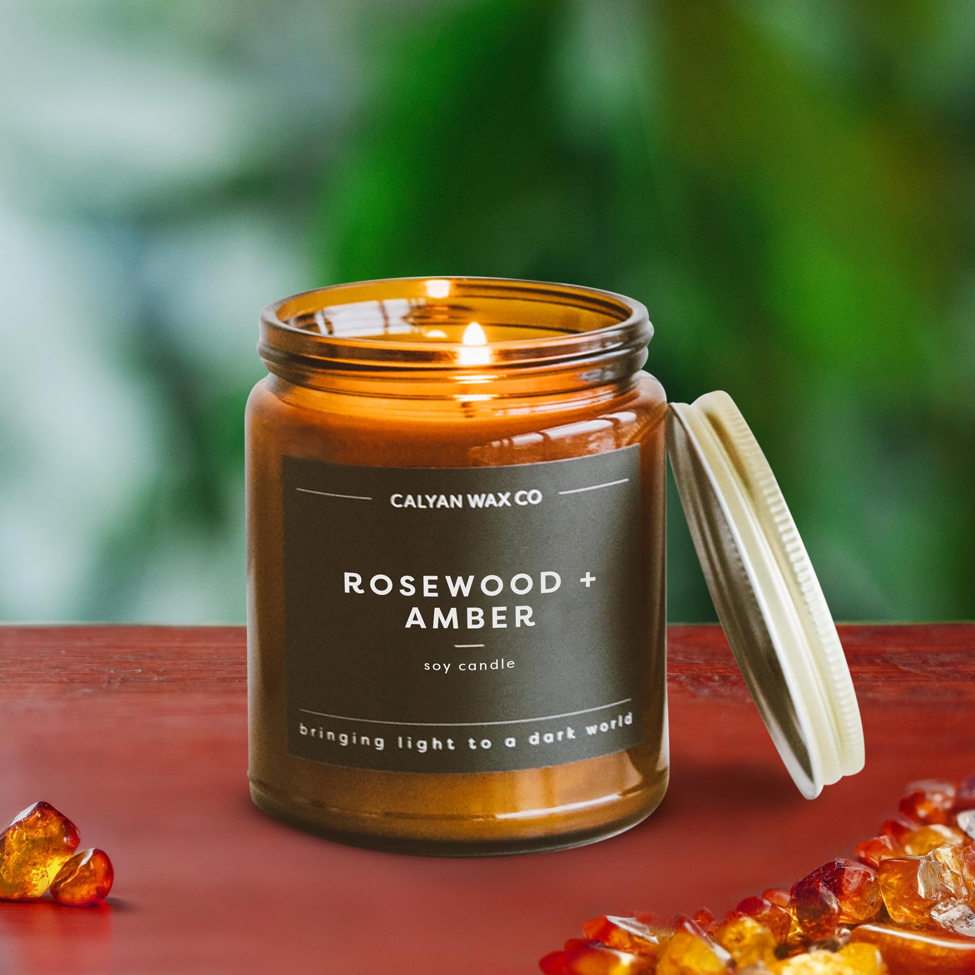 Calyan Amber Candle glass jar on a coffee table creating inviting ambiance.