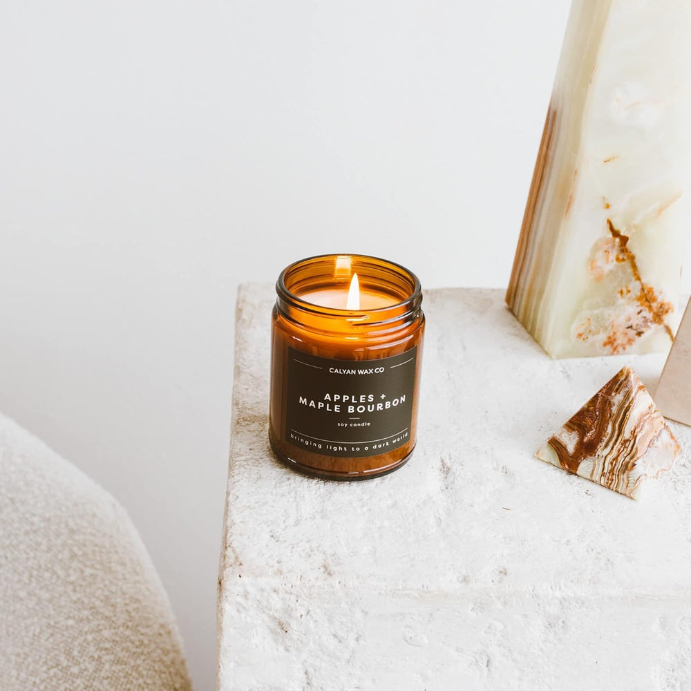 Calyan Wax Co amber jar candle in a living room setup