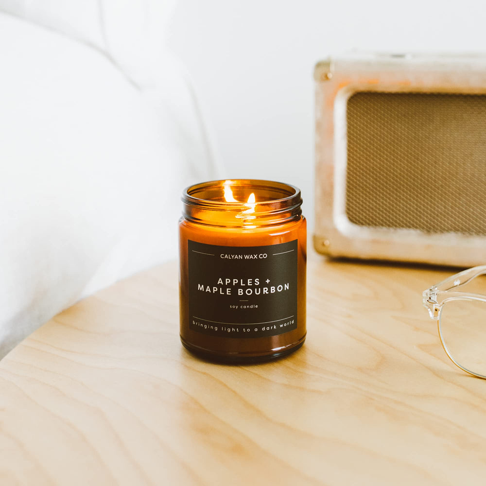 Calyan Wax Co. Apples & Maple Bourbon candle emits a warm glow for relaxing evenings.