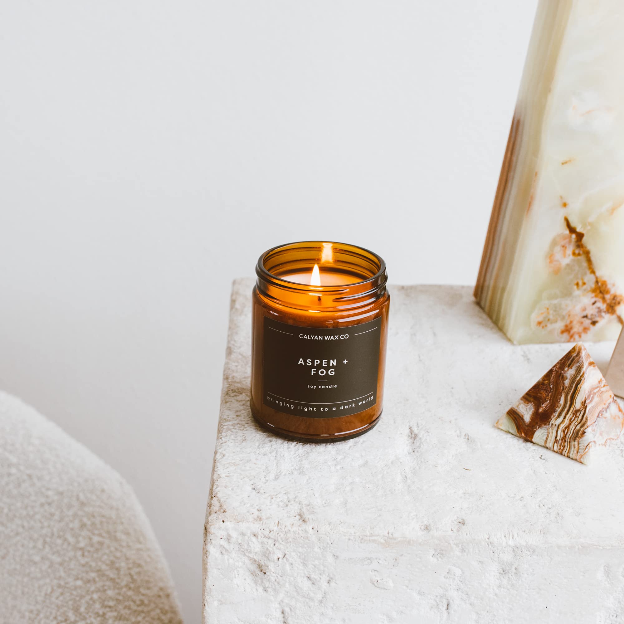 Aspen & Fog candle in a cozy living room ambiance setting