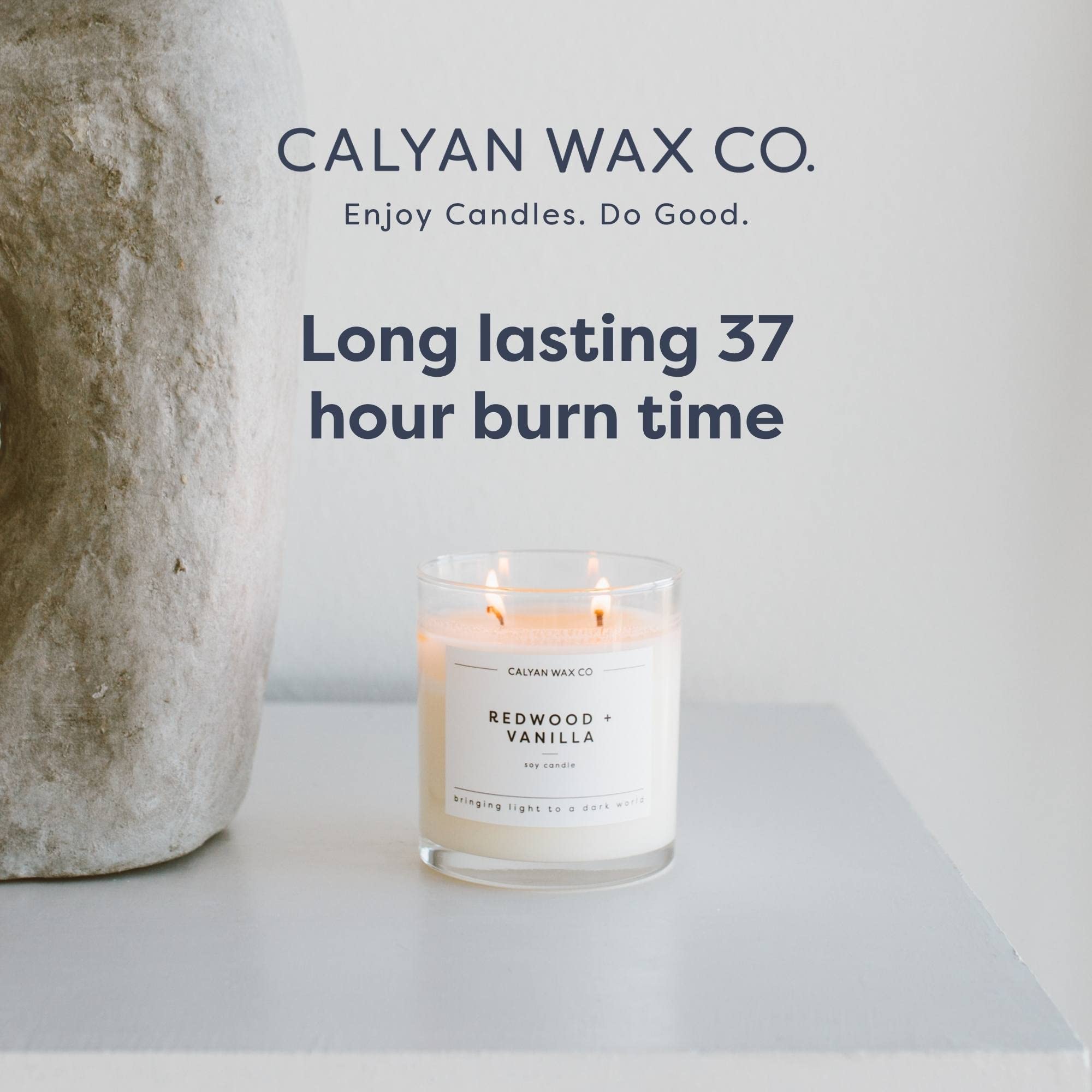 Calyan Wax Co. evergreen-eucalyptus candle on coffee table adds refined mood.