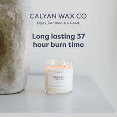 Calyan Wax Co. evergreen-eucalyptus candle on coffee table adds refined mood.