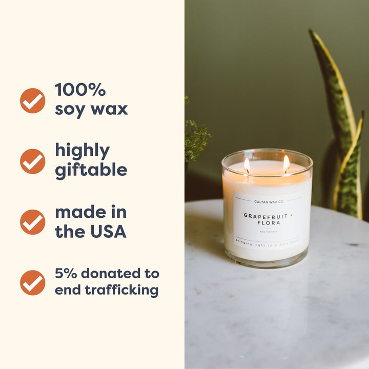 Calyan Wax Co. candle glow enhances living room warmth with eucalyptus and fir.