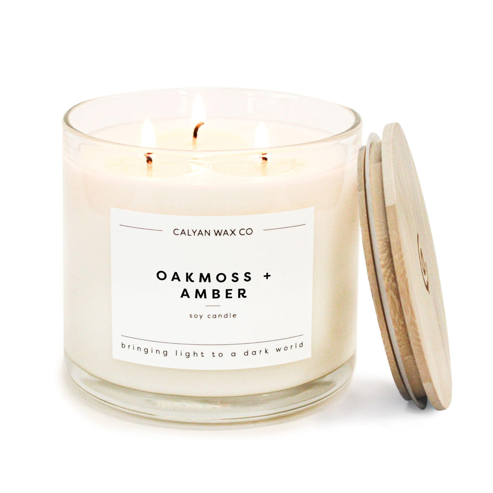 Calyan Wax Co Oakmoss Amber 3-wick candle in glass jar for ambient home glow