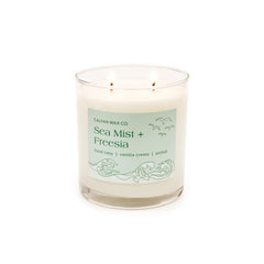 Calyan Wax Co Sea Mist & Freesia 2-wick candle in a glass jar for living rooms.