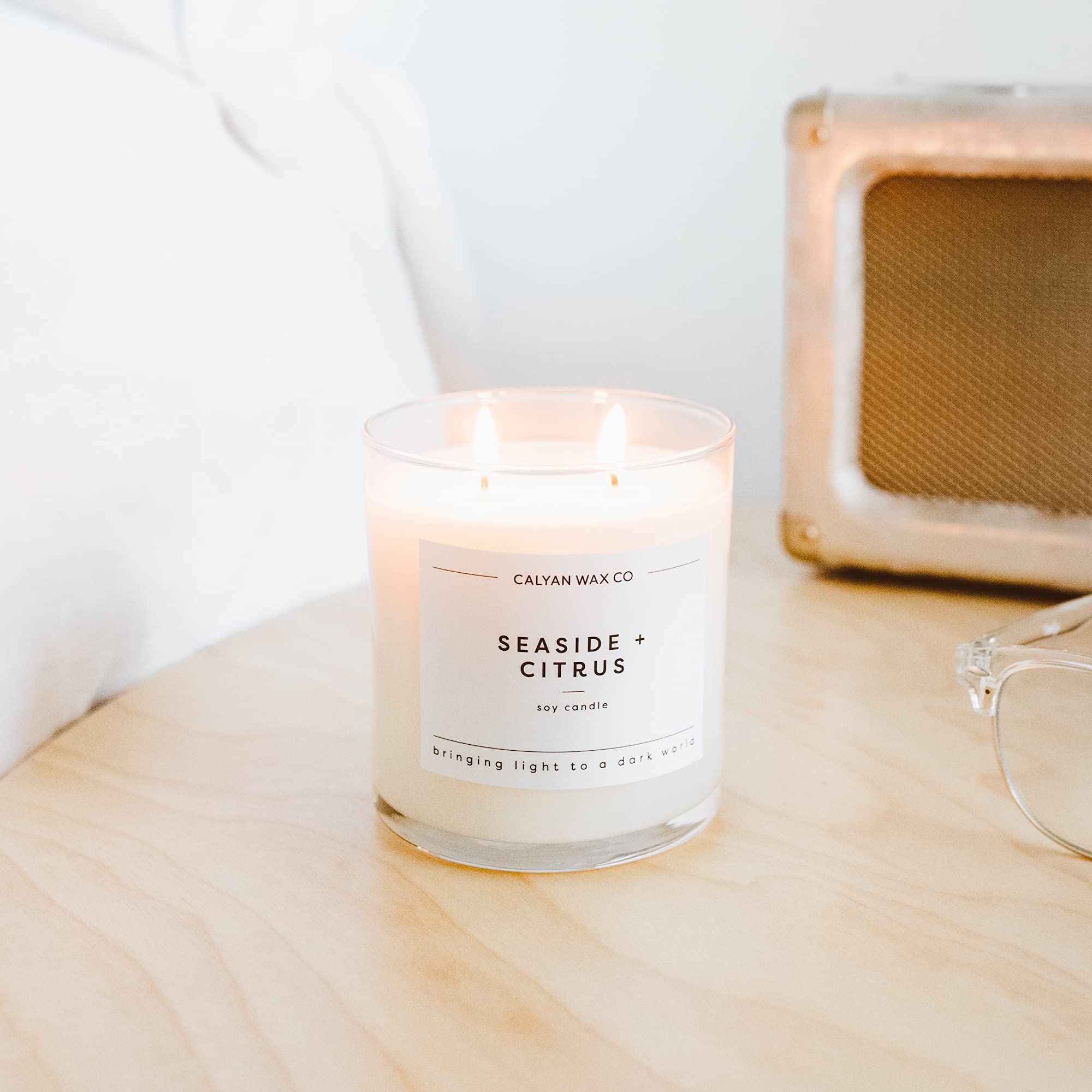 Seaside & Citrus room ambience featuring Calyan Wax Co candle in a bedroom.