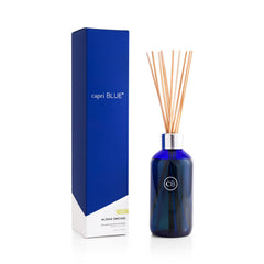 Capri Blue Aloha Orchid diffuser bottle with vibrant blue glass for lasting room scent