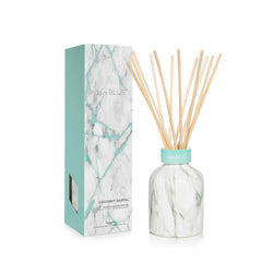 Capri Blue Modern Marble Coconut Santal diffuser bottle enhances room fragrance and decor.