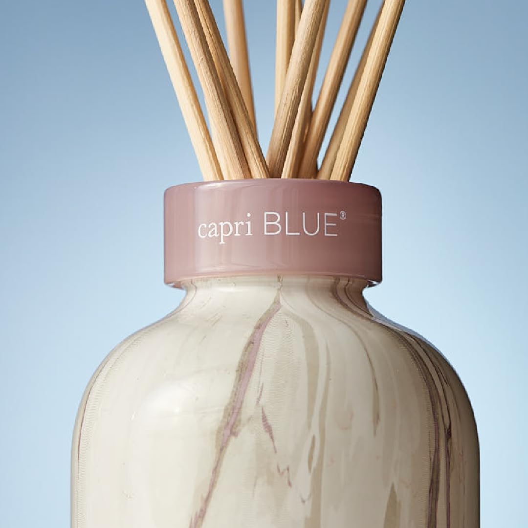 Capri Blue diffuser on a table elevates living spaces.