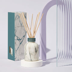 Capri Blue Modern Marble Reed Diffuser Set reed sticks release subtle fragrance.