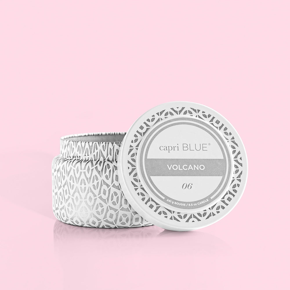 Capri Blue Volcano travel tin close-up shows white and silver design adding luxe ambience.