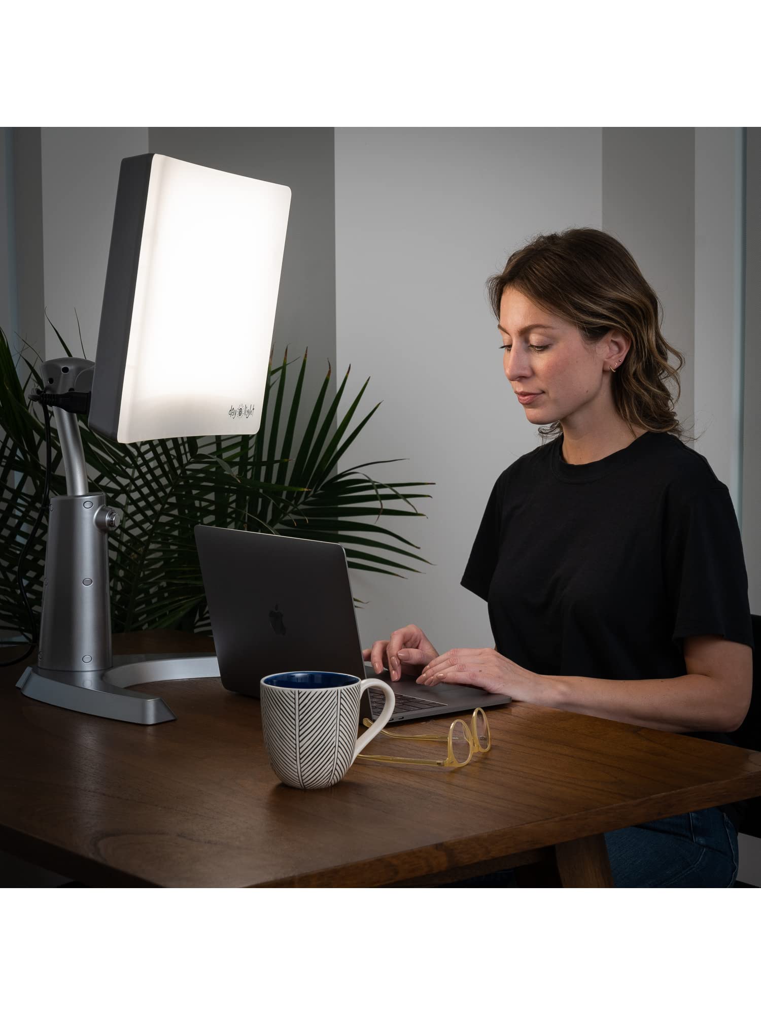 Carex Day-Light height-adjustable stand fits desks, couches, and beds.