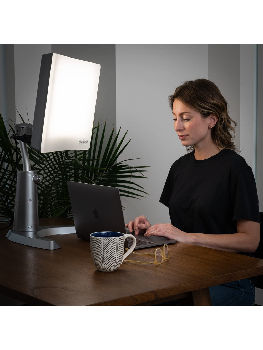 Carex Day-Light height-adjustable stand fits desks, couches, and beds.