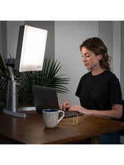 Carex Day-Light height-adjustable stand fits desks, couches, and beds.