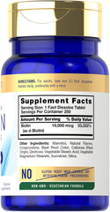 Carlyle Biotin berry-flavor fast-dissolve tablets close-up in hand.