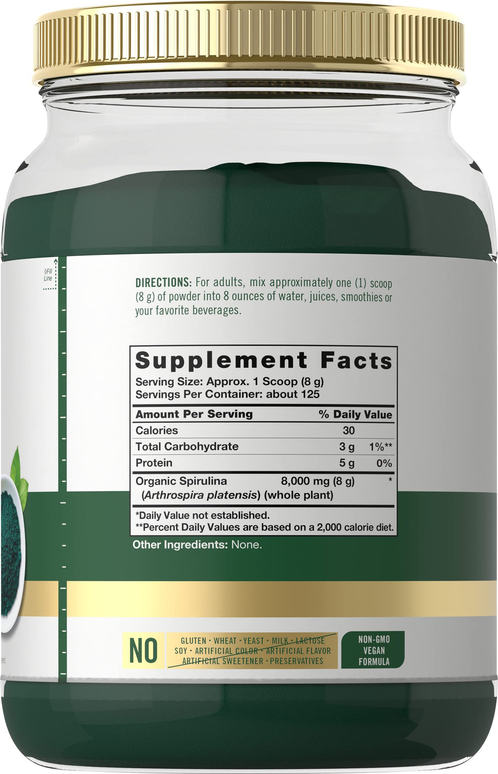 Carlyle spirulina powder scoop beside glass for easy mixing.