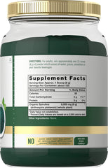 Carlyle spirulina powder scoop beside glass for easy mixing.