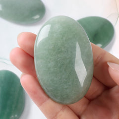 Casmon green aventurine palm stone placed in crystal grid for balance