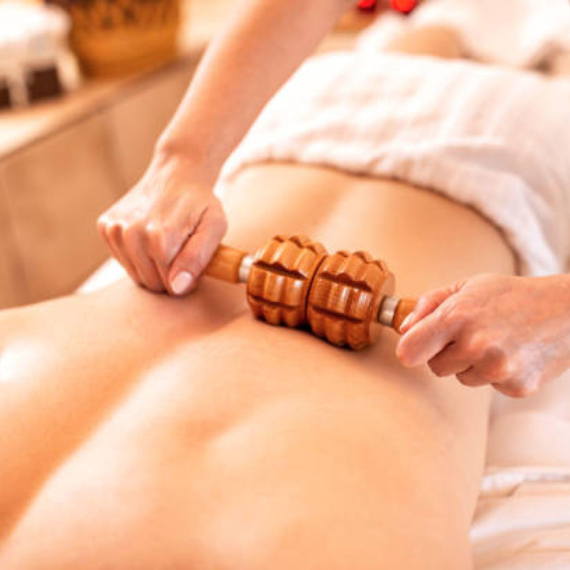 Cel-Lite Magic Massage Oil pours into hand for a soothing session.