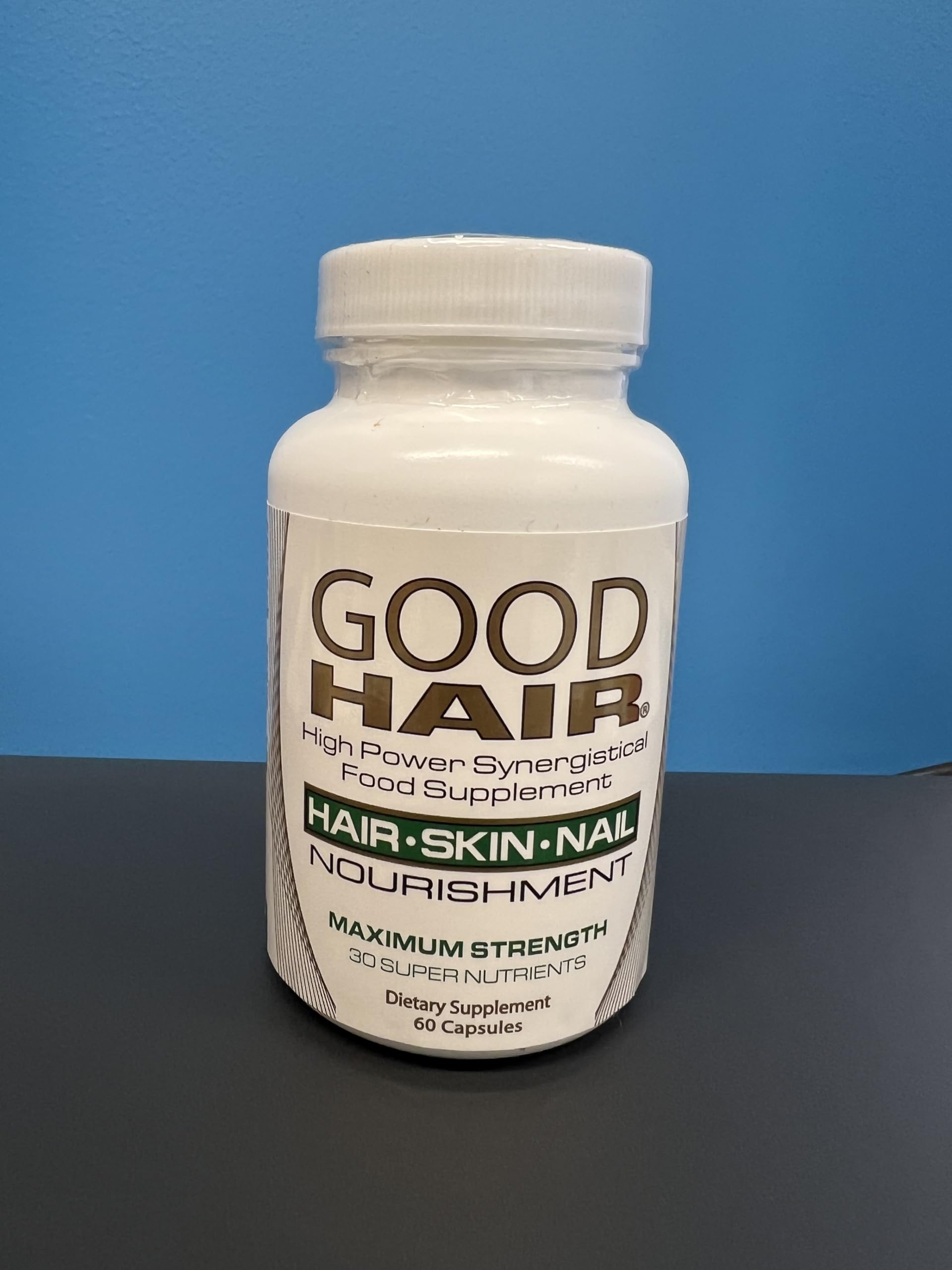 Century Systems Good Hair capsules in hand suggest convenient daily capsules for hair and nail support.