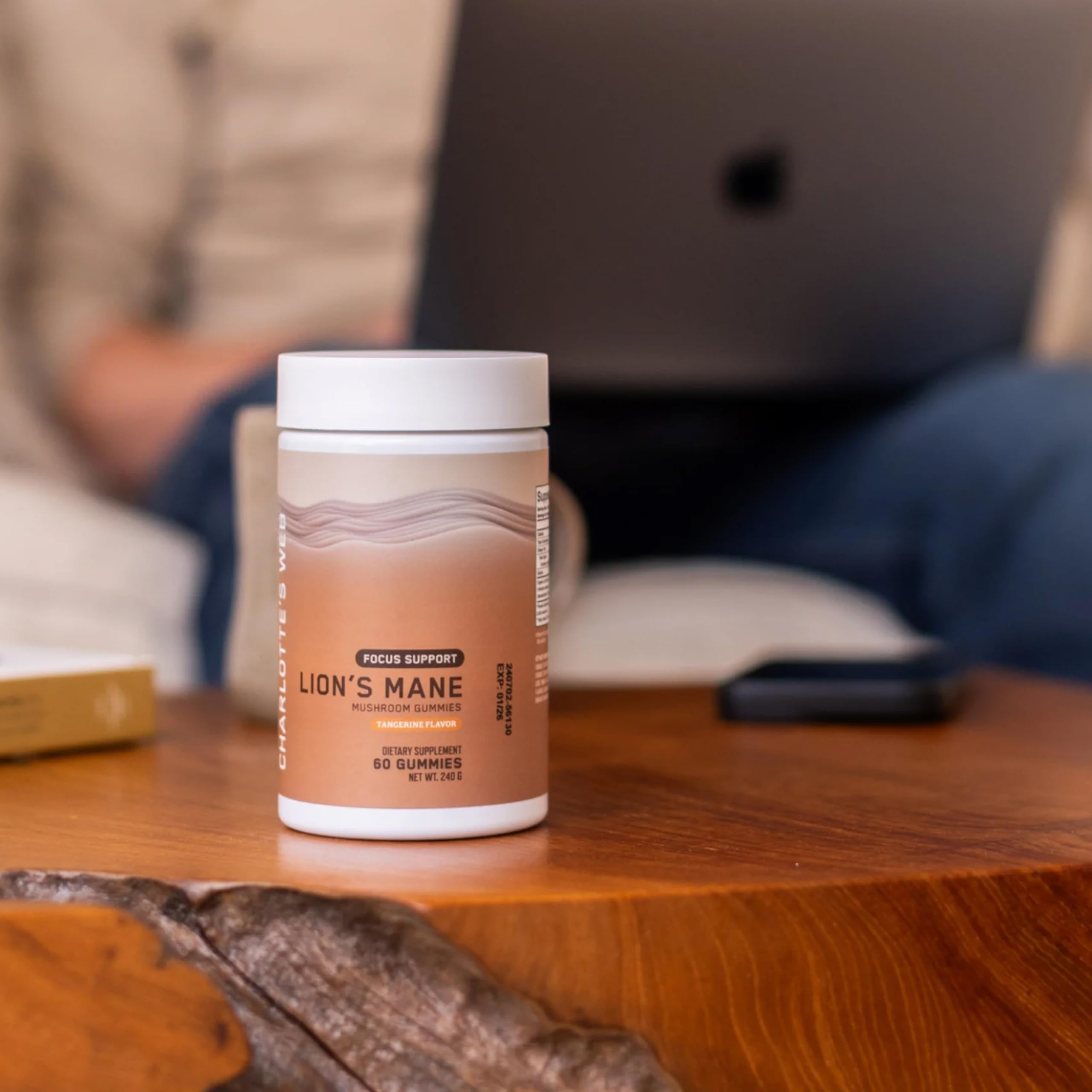 Charlotte's Web gummies on wooden desk with third-party testing seal