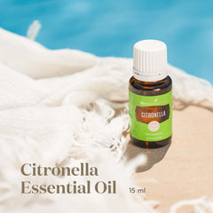 Young Living Citronella bottle beside lemons and leaves for refreshing aroma.