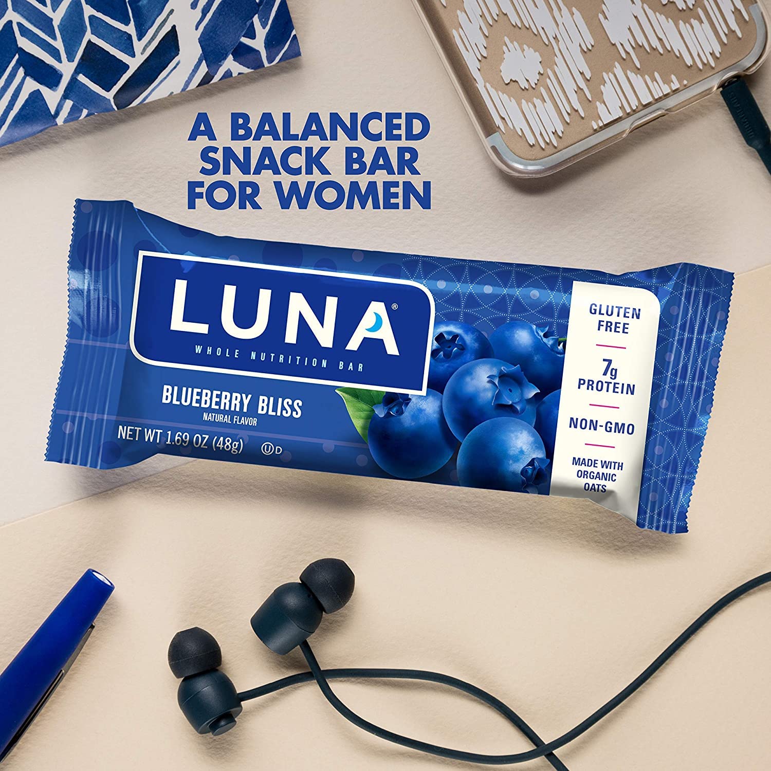 CLIF LUNA Blueberry Bliss hand-holding bar as a quick vegan snack.