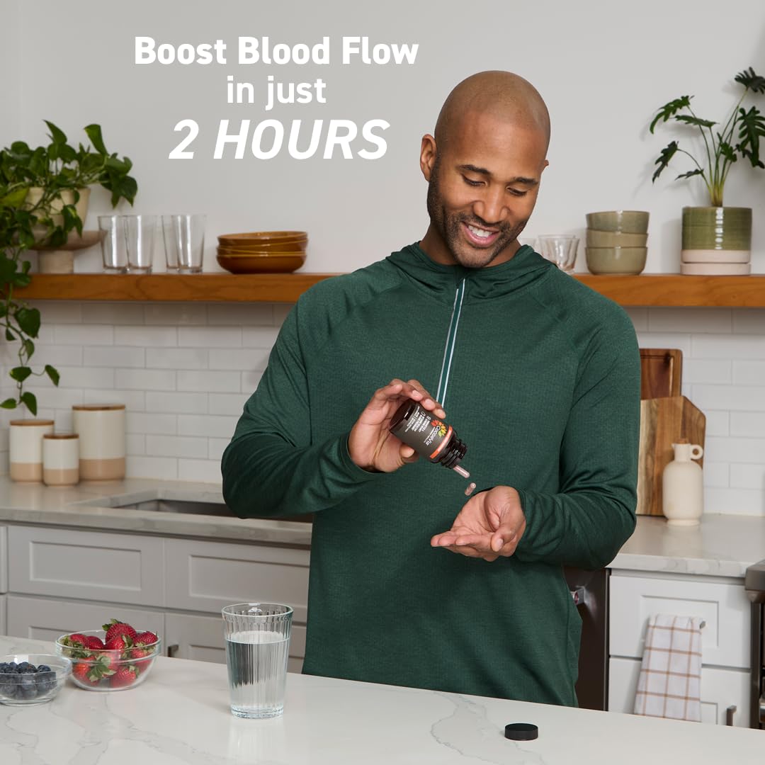 CocoaVia Cardio Health capsules in glass suggesting convenient daily use.