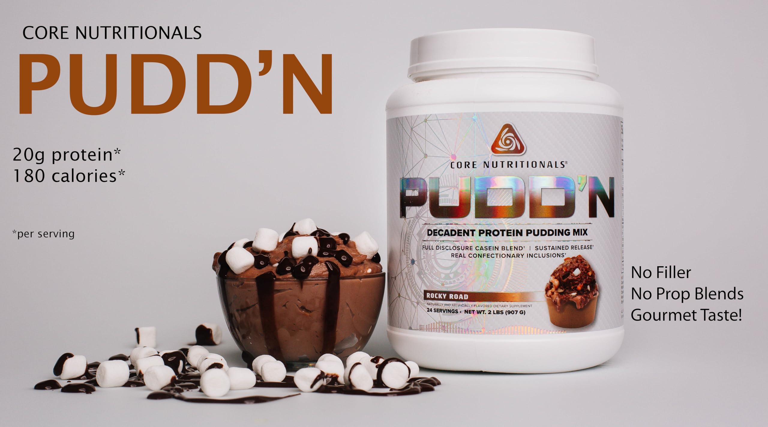 Core Nutritionals Pudd'n Rocky Road spoon lifting smooth pudding for a satisfying snack.