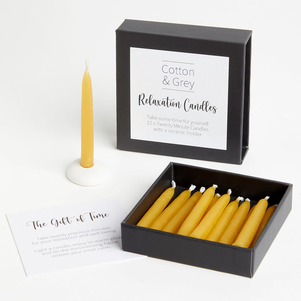 Cotton & Grey relaxation candles on a ceramic holder create a calm ambience.
