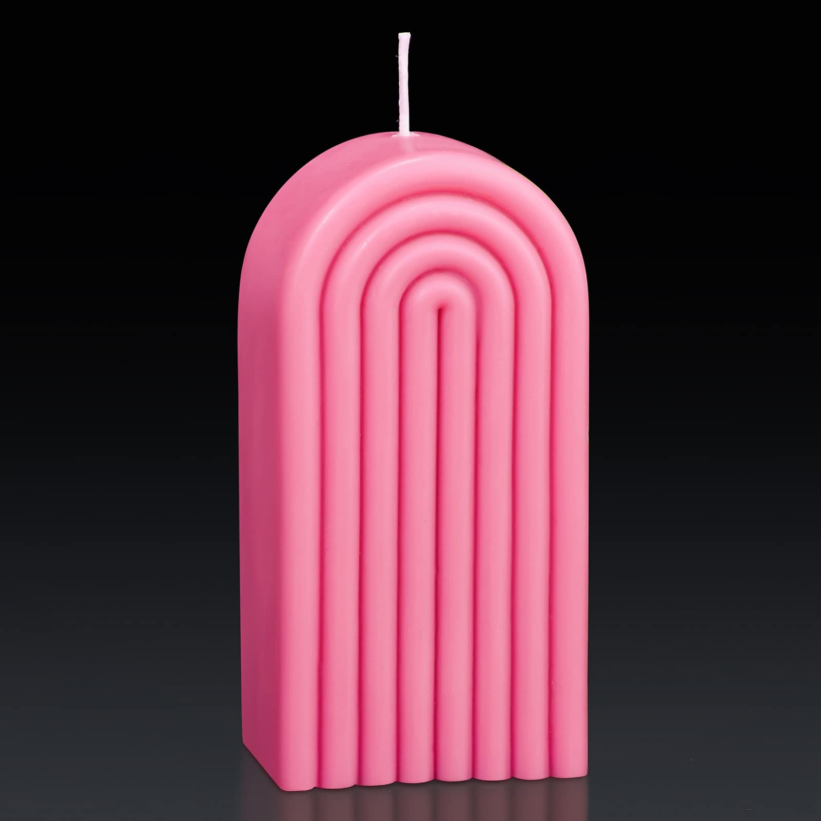 Coume arch-shaped pink candle enhancing cozy ambiance