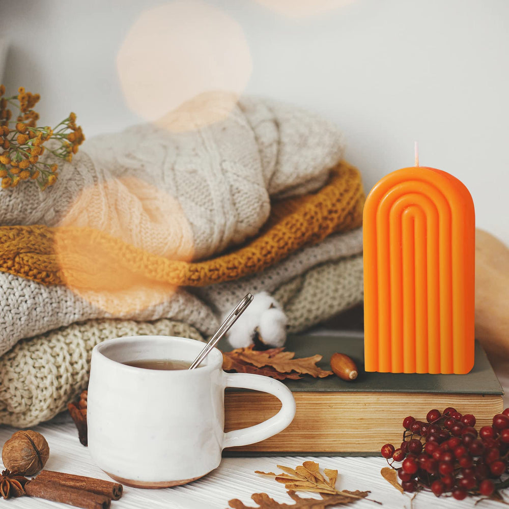 Coume minimalist arch candle in orange enhances contemporary interiors.